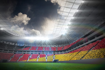 Digitally generated german national flag against football stadium with fans in white © vectorfusionart