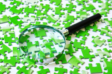 magnifying glass on the green puzzle