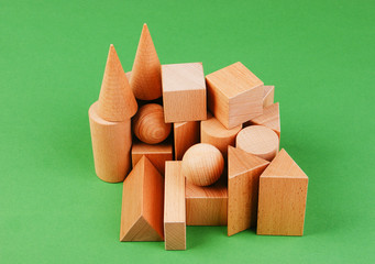 wooden geometric shapes on a green background