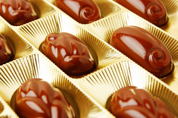 chocolate candies in a gold gift box