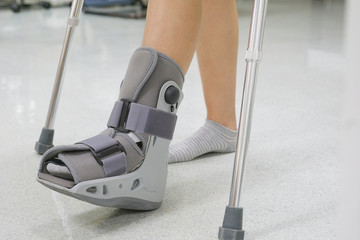 Orthopaedic Boot and crutch to a Patient. medical orthopedic concept.