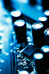 computer board capacitors blue color close-up