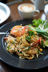 Fried noodle Thai style with prawns, selective focus