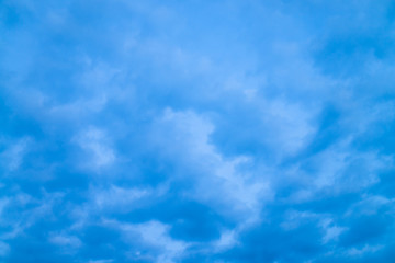 Cloudy blue twilight sky close-up. Overcast weather. Dramatic background from many rainy clouds.