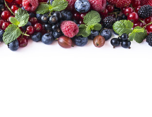 Mix fruits berries isolated on white background. Ripe currants, raspberries, blueberries, gooseberrie, blackberries. Top view.