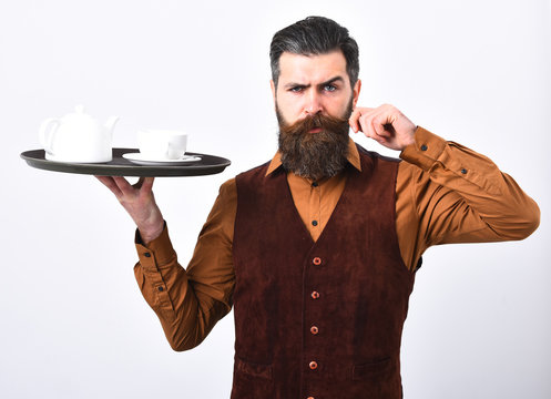 Waiter with white tea cup and pot on tray.