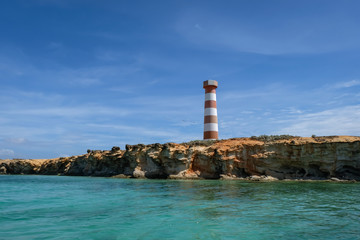 Tropical seascape with a light house along the coast of Cubagua island (Venezuela).