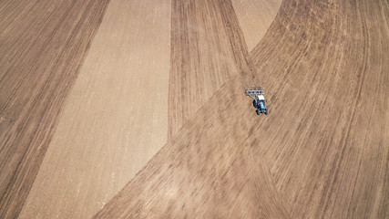 Naklejka premium Farm machinery on the field. Agricultural landscape from the air