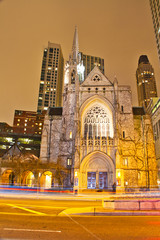 Chicago’s Fourth Presbyterian Church at night with motion blurs from traffic.