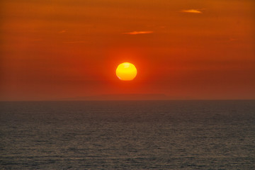 The sun setting over the Pacific Ocean off the coast of California.