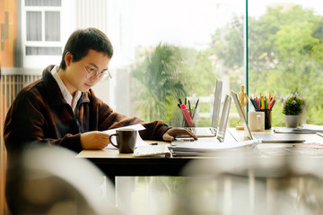 Young Asian businessman working with laptop at office