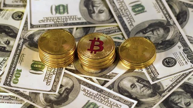 Pile bitcoin btc bit-coin lie on hundred-dollar bills of United States. Rotation. Mining. Cryptocurrency. Economy. Cyberspace. Background.