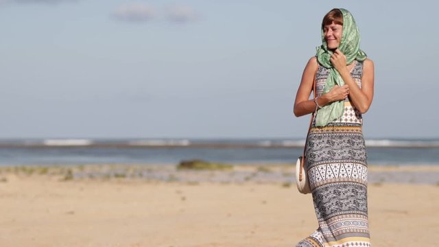 Woman with fashionable stylish yellow white bag on the beach. Tropical island of Bali. Handmade Rattan eco handbag HD footage.