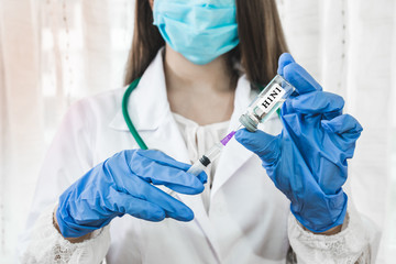 Anti flu vaccination, nurse with syringe and ampoule