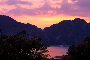 A golden hour sunset over the mountains at Koh Phi Phi Don island along the Andaman cost of Thailand.
