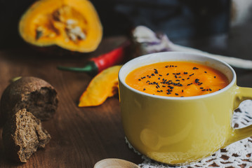 Homemade vegetable soup with pumpkin with cream and black sesame, top view