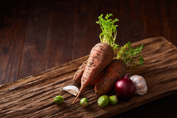 Artistically served vegetable salad with carrot, cucumber, letucce over wooden background,...