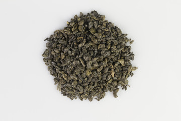 Heap of green gunpowder tea pellets on white background
