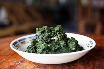 Fried swamp algae (Wolffia globosa) in white dish. Vegetarian food with benefits. Thai local food menu.