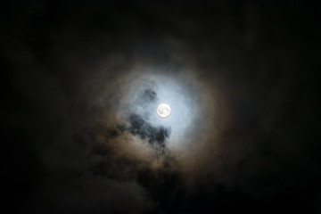 a full moon surrounded by a sea of ​​clouds