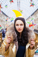 Beautiful brunette woman in golden fur coat