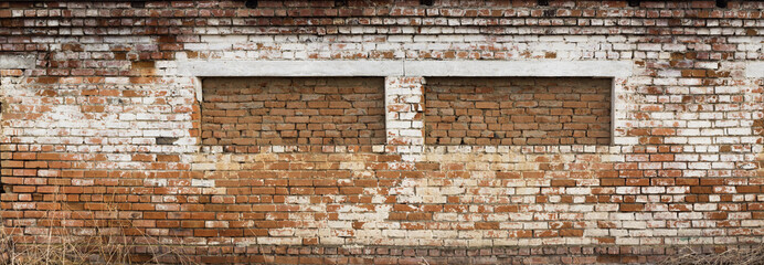 Brick wall with two windows overlooking the panorama