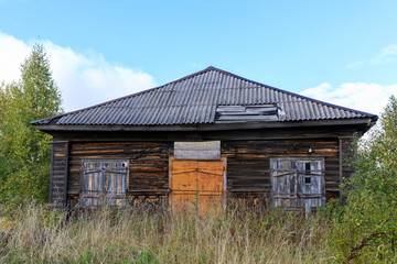 Destroyed and abandoned wooden shop in the village