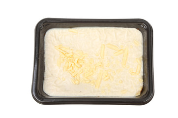 Uncooked lasagna in a carton