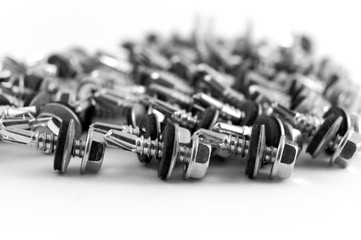 Special roofing screws with a drill, washer and rubber sealing gasket on a white background.