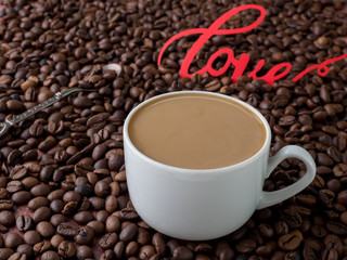 Cup of coffee with milk on background of coffee beans
