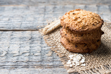 Oatmeal cereal cookies on napkin burlap wood table