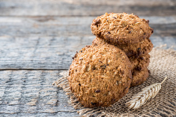 Oatmeal cereal cookies on napkin burlap wood table