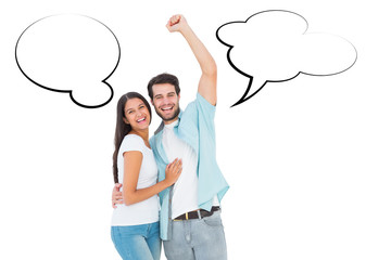 Happy casual couple cheering at camera against speech bubble