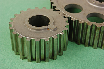 Two gears on a green background