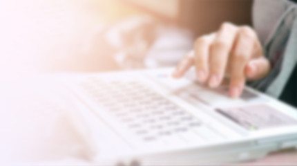 blurred background hand on keyboard, insurance concept