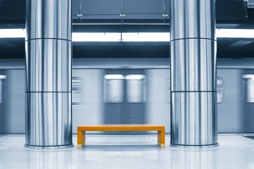 Moving train in subway station. Toned image