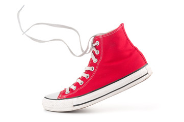 Single red sneaker on white background - obrazy, fototapety, plakaty