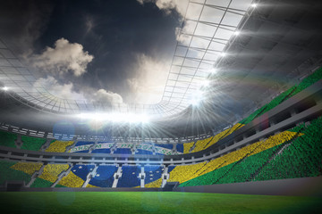 Digitally generated brazilian national flag against football stadium with fans in white