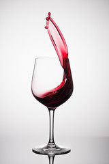 red wine splashing out of a glass