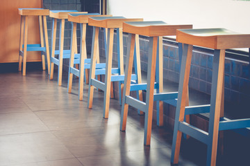 Abstract architecture row of empty vintage wooden chairs decorate in coffee cafe. (Selective focus)