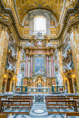 Fototapeta na wymiar Altar in the transept of the Basilica of the Santi Ambrogio e Carlo al Corso, in Rome, Italy.