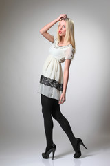 fashion model in dress posing in studio