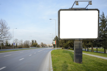 blank Billboard in the side of a road , fork or crossroad with blank billboard.