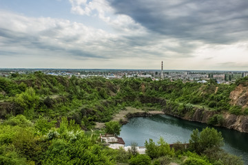 soft focus industrial factory pollution concept on natural quarry landscape with lake