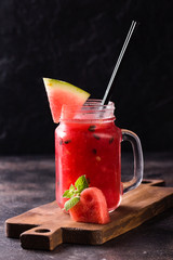 Fresh watermelon Smoothie in the Mason jar on dark background