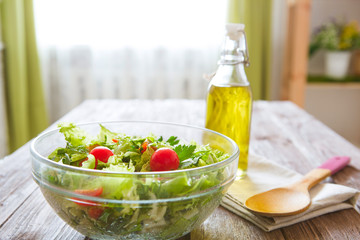 Tasty salad in a bowl on wooden table. Concept healthy lifestyle and simple food