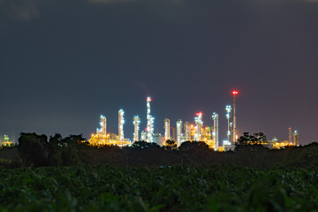 Night view over petroleum power plant industrial background.