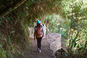 Girl walking in forest trail