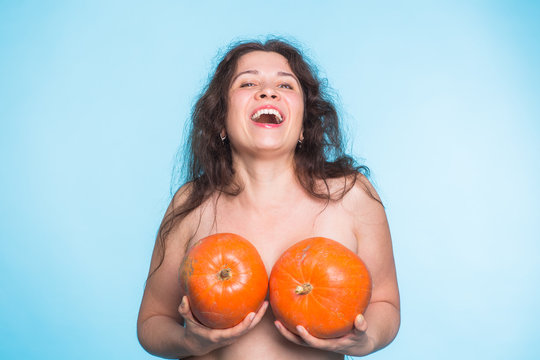 Pumpkins on a female breast - concept silicone breast and plastic surgery.