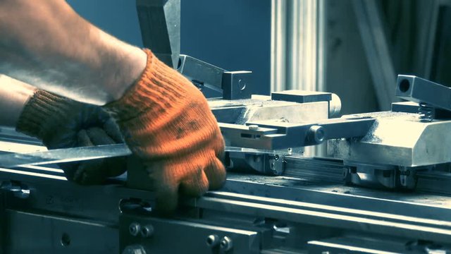 Factory worker operates with hydraulic bending machine on the plant. Metal working concept